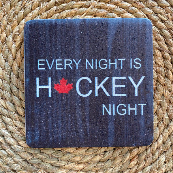 Coaster with 'Every Night is Hockey Night' text and maple leaf on a woven mat