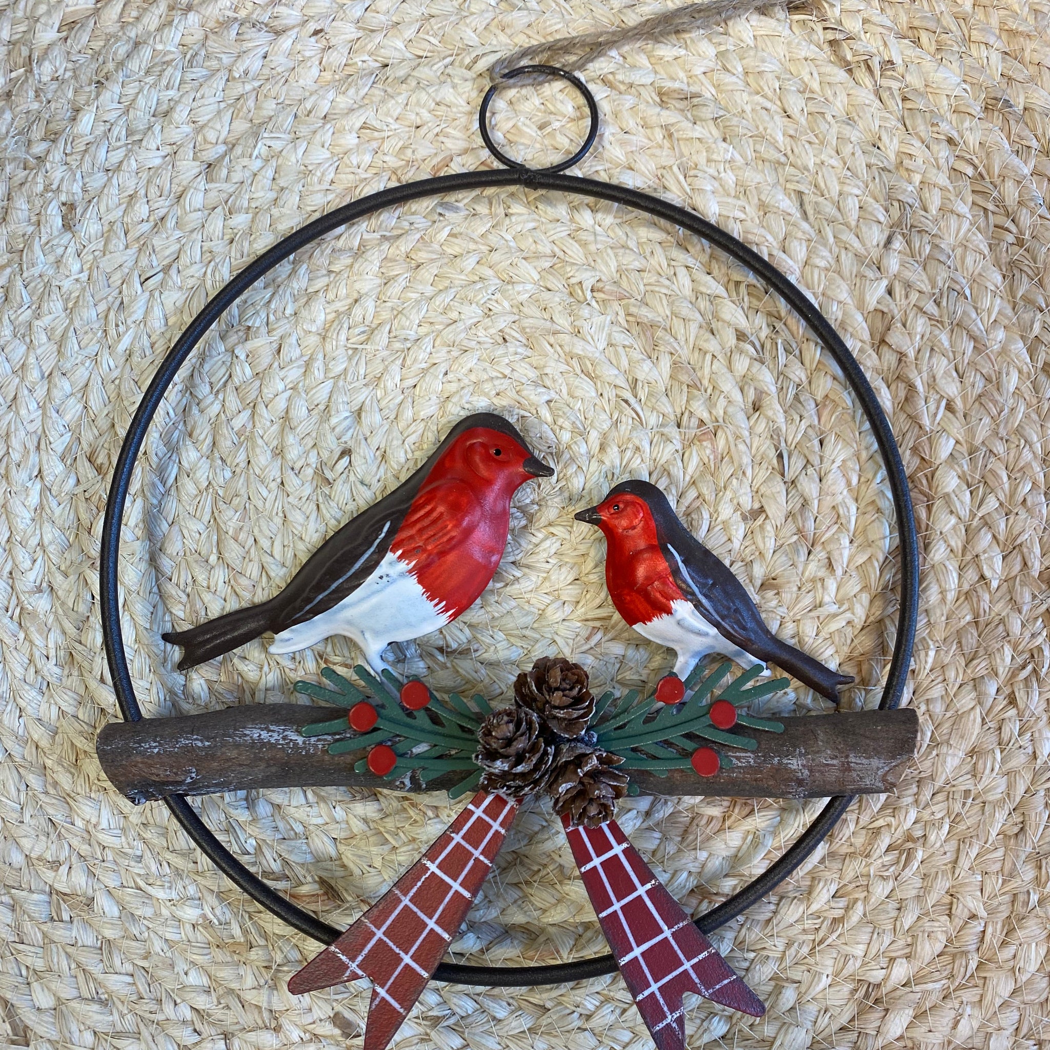 Decorative wall art with birds and nature elements on a woven background