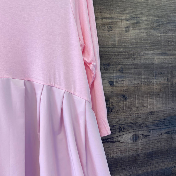 Close-up of pink fabric with a wooden background