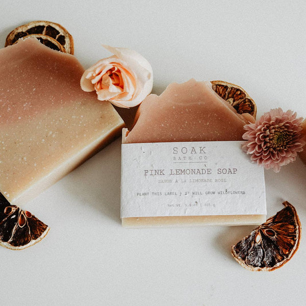 Pink lemonade soap bar with packaging and decorative elements on a light background