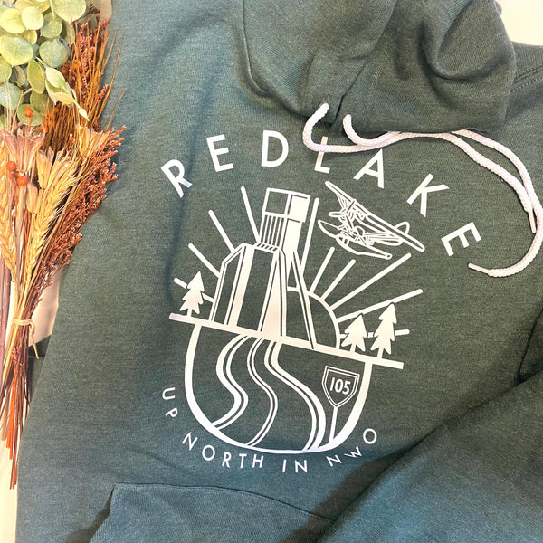 A heather forest green hoodie with RED LAKE and a mine shaft, Norseman plane, sunset, trees and hwy 105 depicted.