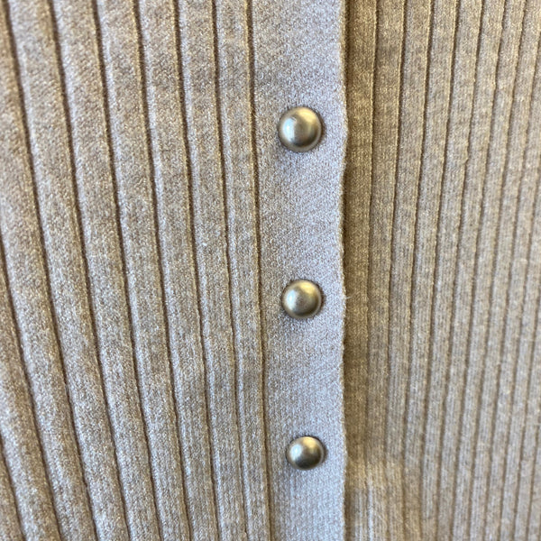 Close-up of a ribbed knit cardigan in a warm taupe-beige color, featuring a vertical row of metallic gold buttons down the center front.