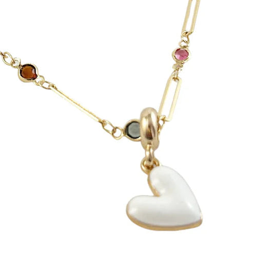 Gold necklace with heart-shaped pendants on a white background