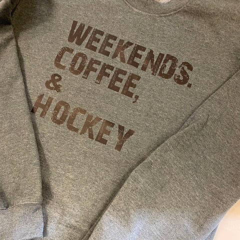 Gray sweatshirt with 'Weekends, Coffee, Hockey' text on a light background