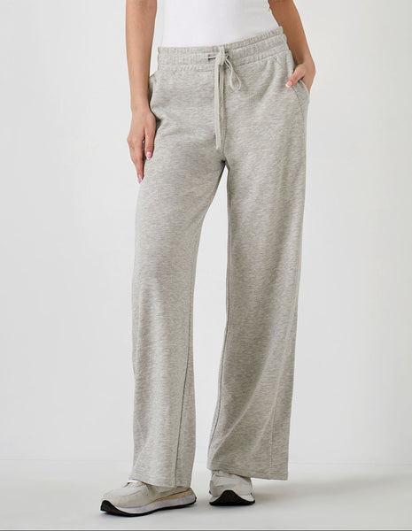 Person wearing gray sweatpants on a white background