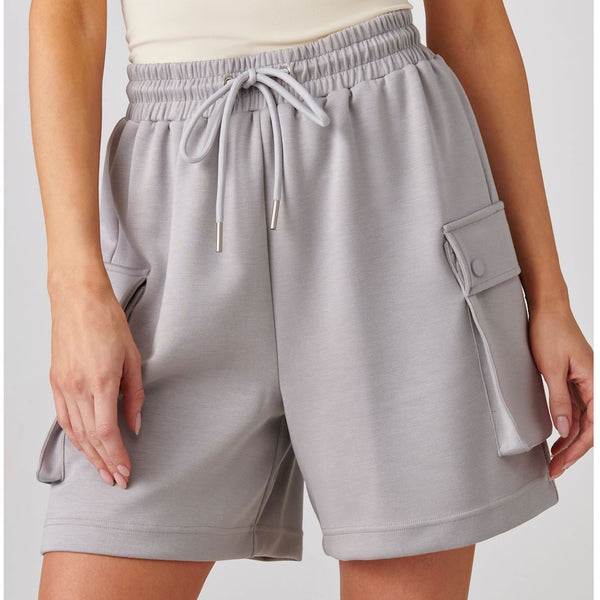 Light gray cargo shorts with a drawstring on a plain background