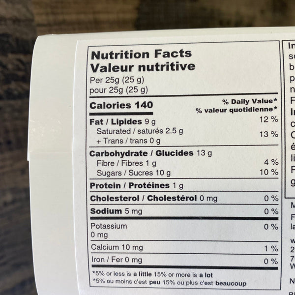 Close-up of a nutrition label on a product with a wooden surface in the background