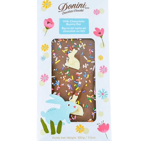 Chocolate bar with sprinkles and bunnies in a decorative box on a white background