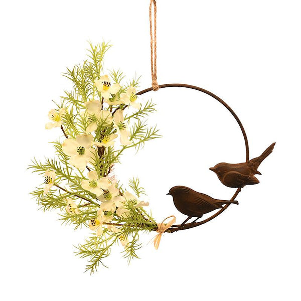 Decorative hanging ornament with greenery and birds on a white background
