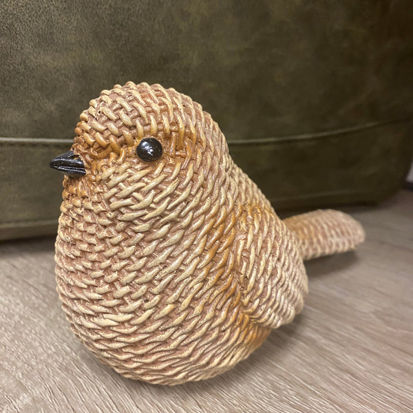 Textured brown bird-shaped object on a wooden surface