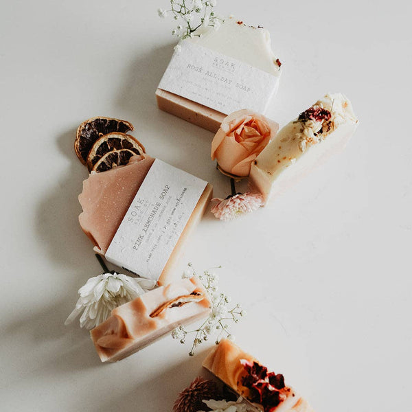 Various soaps with decorative elements on a light surface