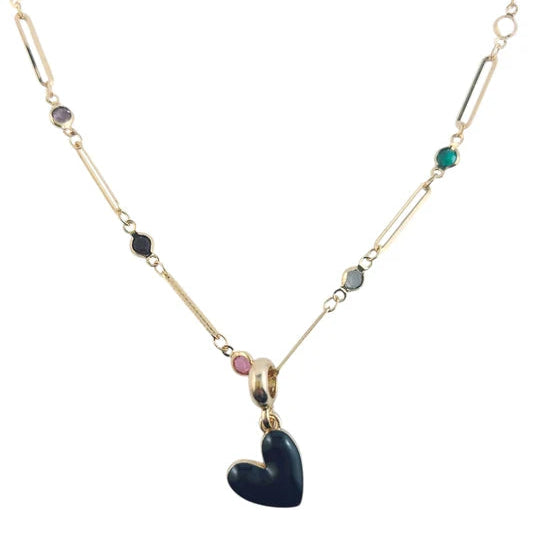 A gold-toned necklace featuring a central dark blue heart pendant, accented with small colorful gemstones along the chain, shown against a plain white background.