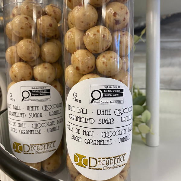 Two containers of Decadence white chocolate truffles on a kitchen counter.