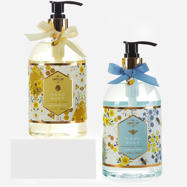 Two bottles of hand soap with decorative ribbons on a white background