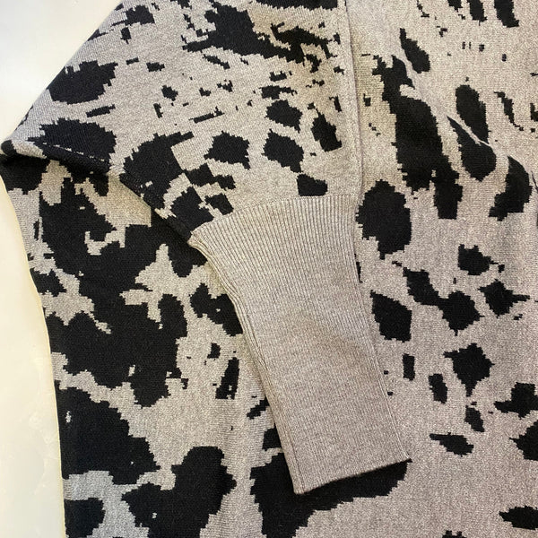 Patterned fabric with black and white design on a neutral background
