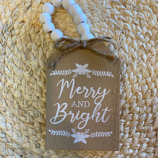 Decorative tag with 'Merry and Bright' text on a woven mat