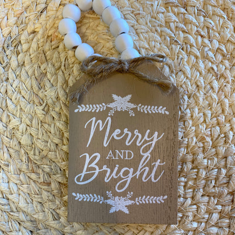 Decorative tag with 'Merry and Bright' text on a woven mat