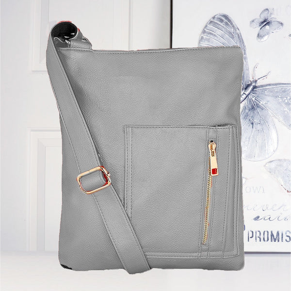 Gray crossbody bag with a gold zipper on a white background