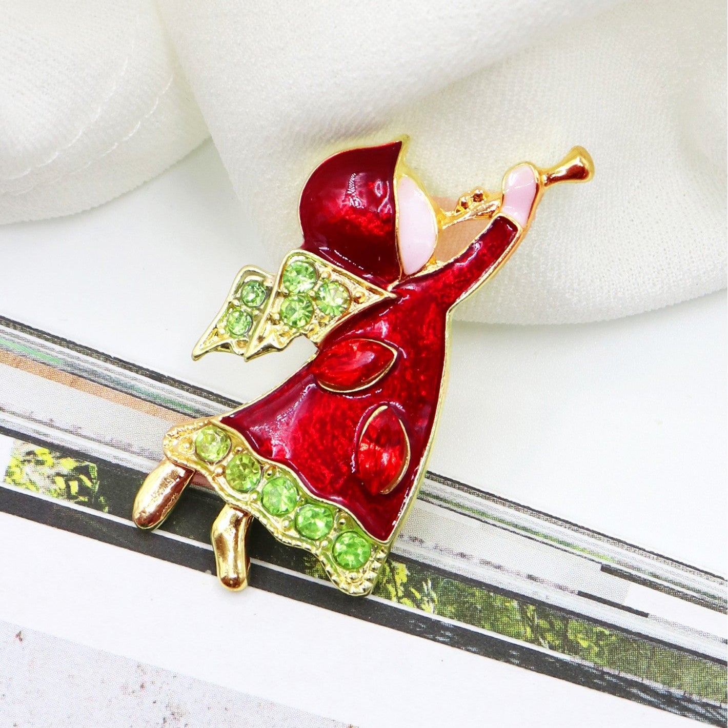 Red and green brooch on a white background