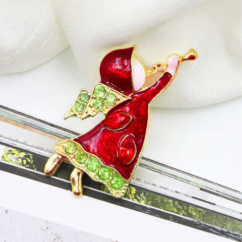 Red and green brooch on a white background