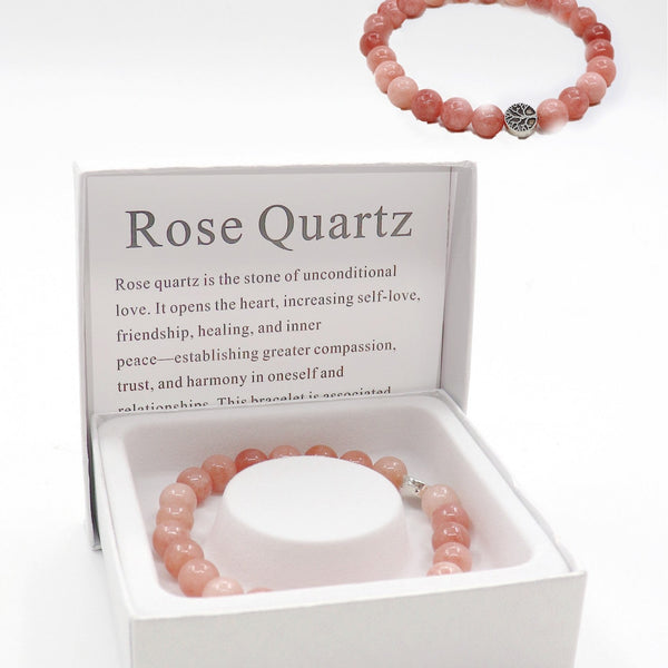 Rose Quartz bracelet in a display box with information about the stone.