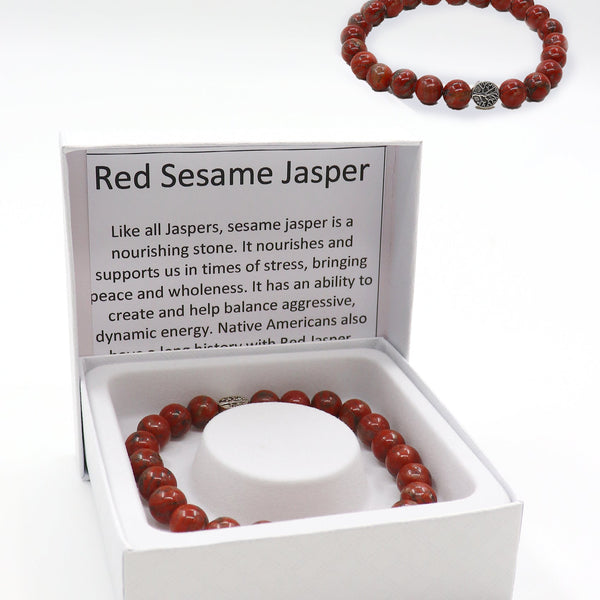 A red sesame jasper beaded bracelet displayed inside an open white gift box with printed product information, plus a second bracelet shown above the box on a white background.