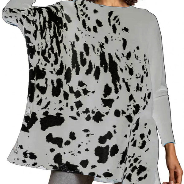 Woman wearing a gray sweater with black and white abstract pattern
