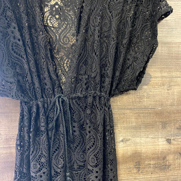 Black lace fabric on a wooden surface