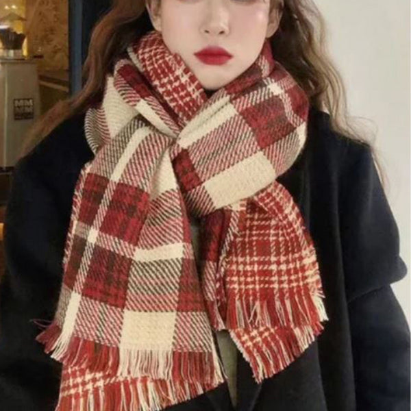 Person wearing a red and beige plaid scarf indoors