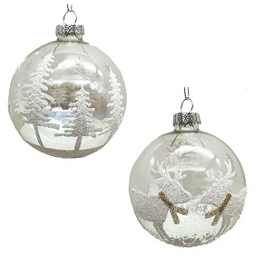 Two glass Christmas ornaments with winter scenes on a white background
