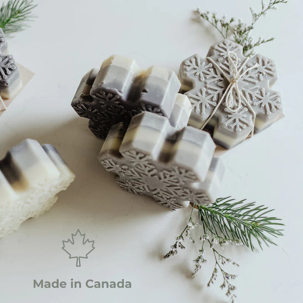 Decorative soap bars with geometric designs on a light background, featuring a 'Made in Canada' label.