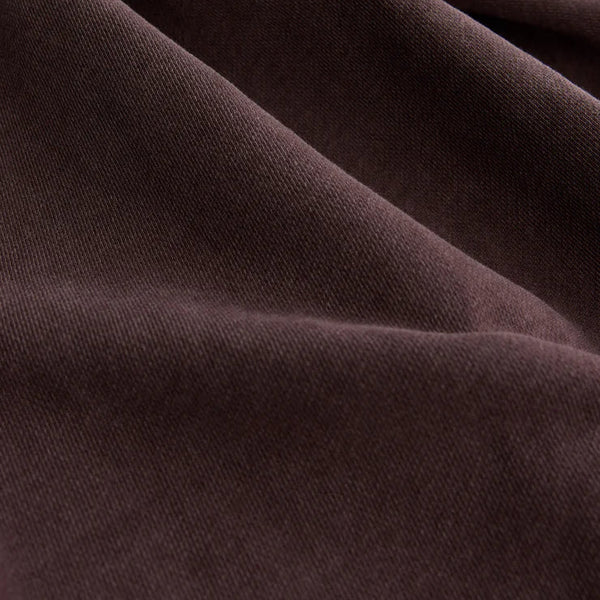 Close-up of dark brown fabric with folds