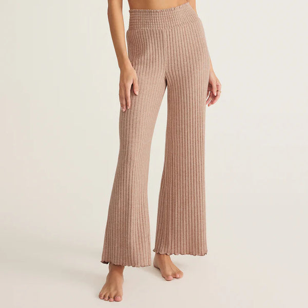 Woman wearing a ribbed knit two-piece set on a beige background