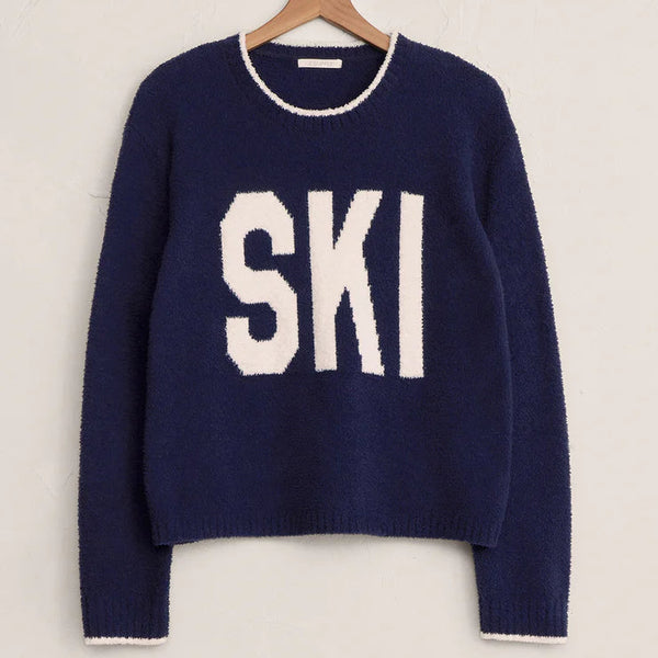 Navy sweater with 'SKI' text on a hanger against a white background