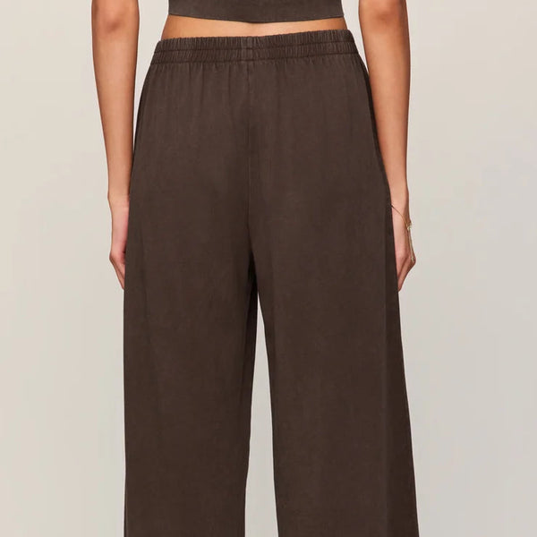 Brown wide-leg pants worn by a person on a plain background