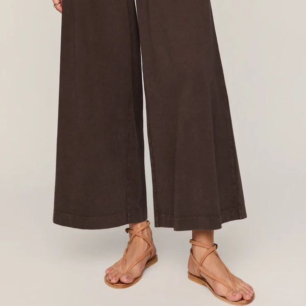 Brown wide-leg pants worn by a person on a plain background