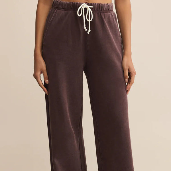 Brown sweatpants with a drawstring on a beige background