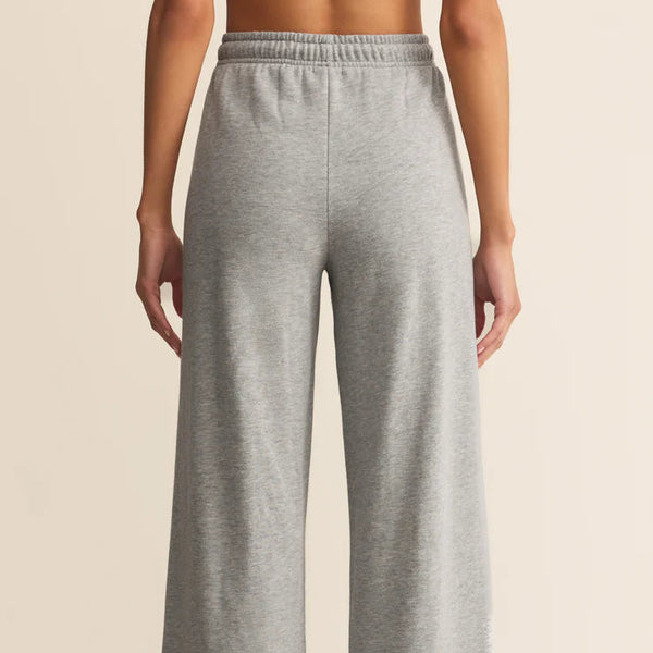 Gray wide-leg pants worn by a person on a beige background