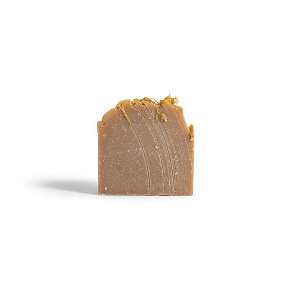 Bar of brown soap on a white background
