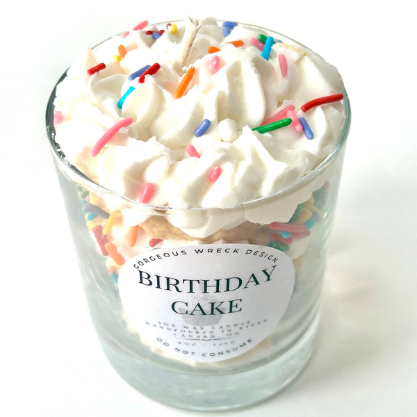 Glass jar labeled 'Birthday Cake' with whipped cream and colorful sprinkles on a white background