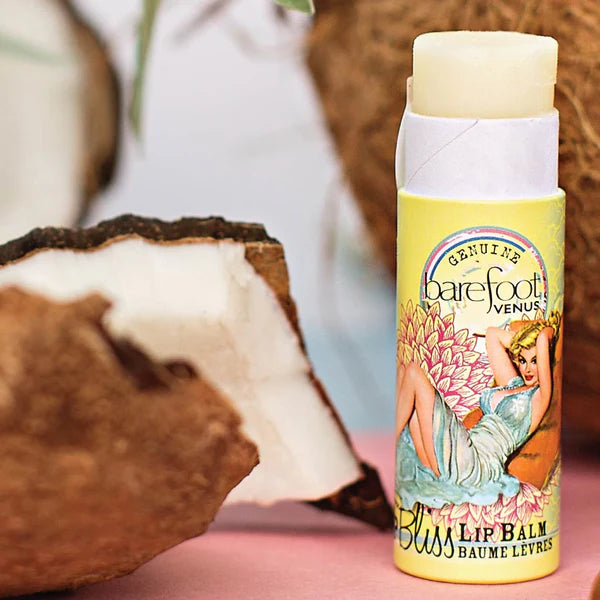 Lip balm with a colorful label featuring vintage-style artwork on a wooden surface.