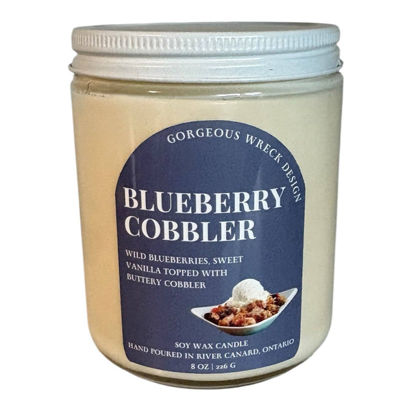 Jar of Blueberry Cobbler candle with a label on a white background