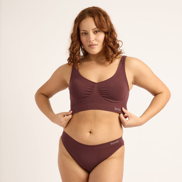 Woman wearing a brown bikini set on a white background